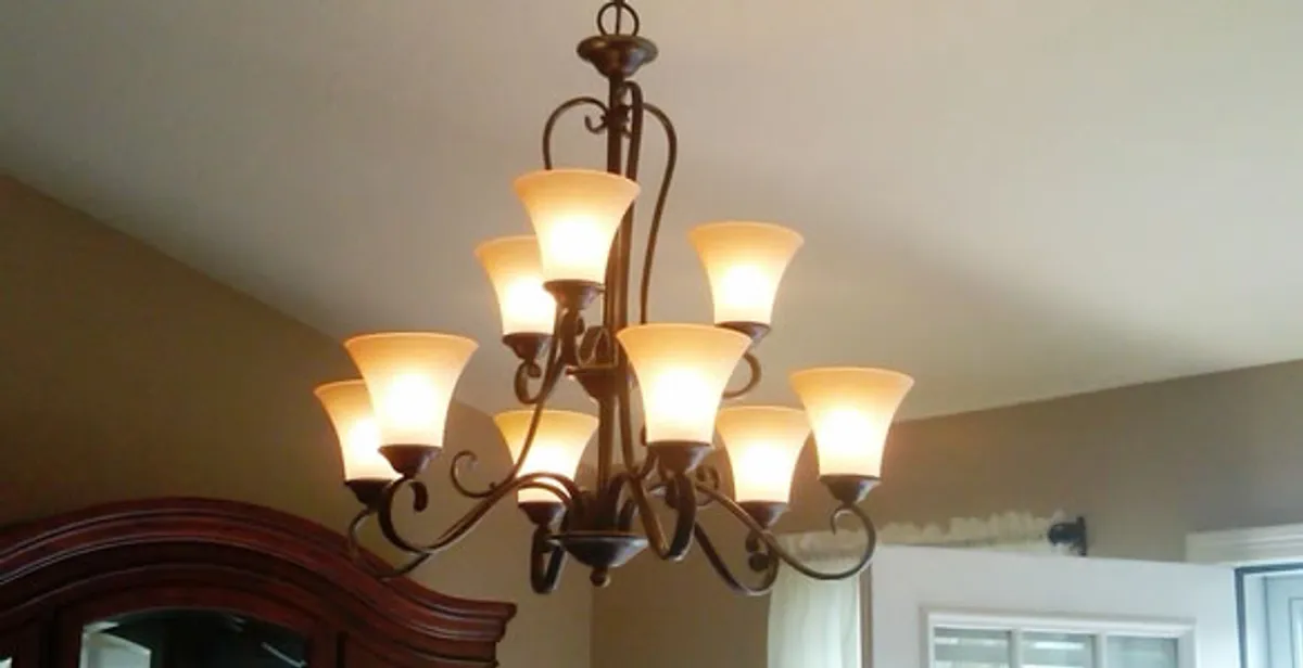 Classic ceiling chandelier installation with warm lighting in Myrtle Beach, SC