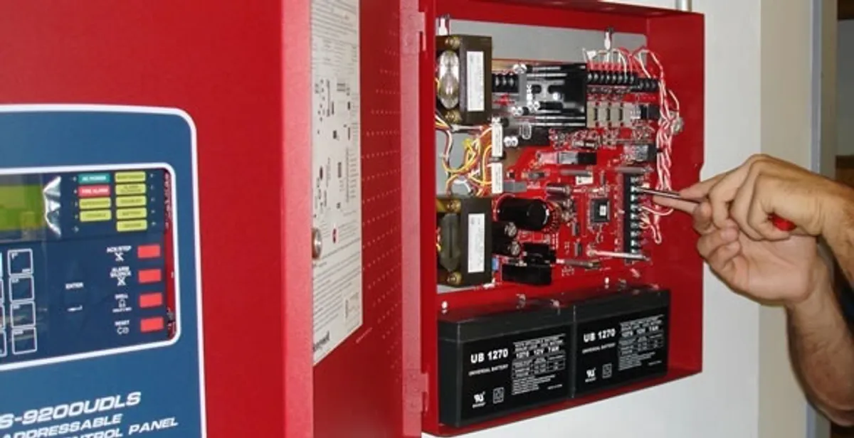fire alarm installation service showing technician configuring fire alarm control panel in Myrtle Beach, SC