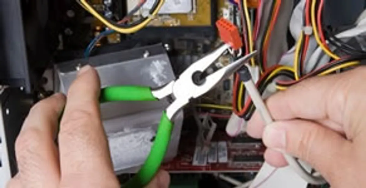 Licensed electrical contractor performing electrical repair with tools in Sunset Beach, NC