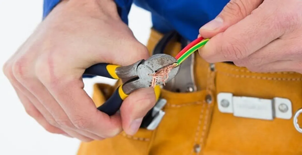licensed electrician securing electrical wiring with professional tools during service work in Myrtle Beach, SC